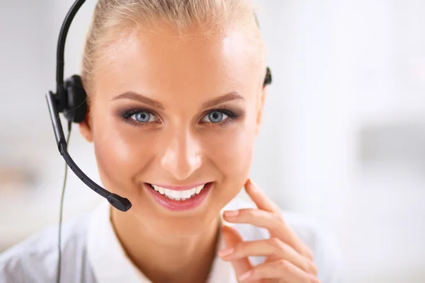 Close-up portrait of a customer service agent sitting at office — Stock Photo, Image