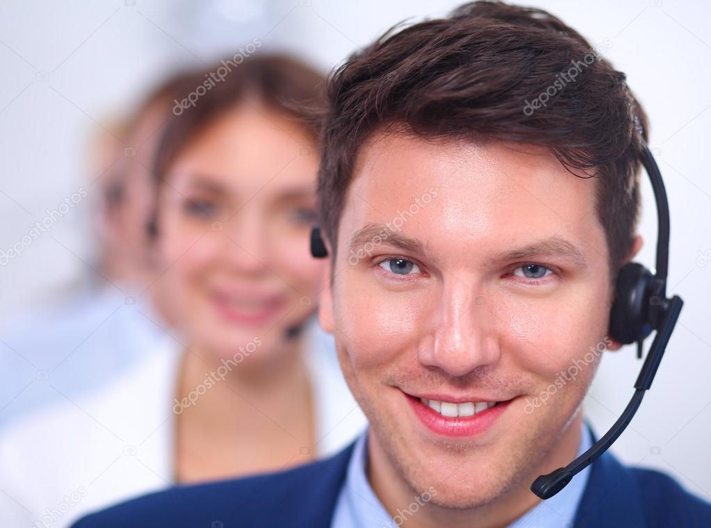 Attractive Smiling positive young businesspeople and colleagues in a call center office