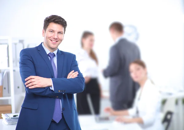 Successful business man standing with his staff in office — Stock Photo, Image