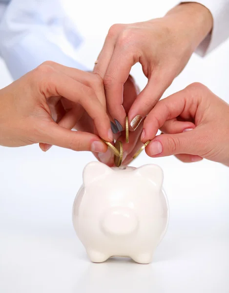 Putting coin into the piggy bank — Stock Photo, Image