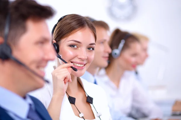 Attractive Smiling positive young businesspeople and colleagues in a call center office — Stock Photo, Image