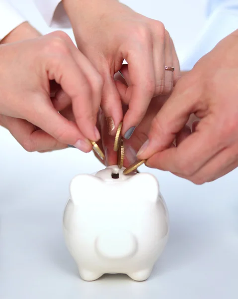 Putting coin into the piggy bank, isolated — Stock Photo, Image