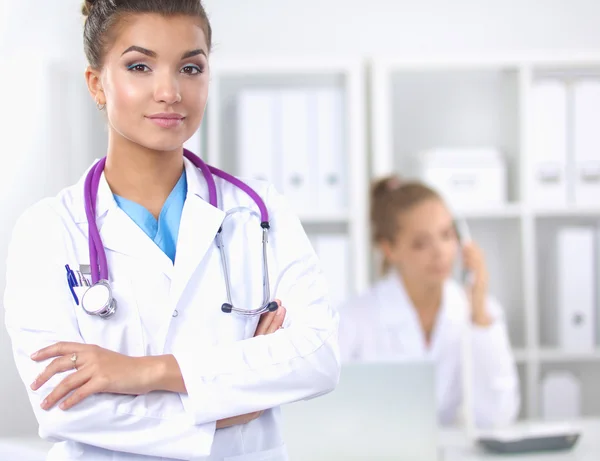 Portrait of young woman doctor with white coat standing in hospital — Stock Photo, Image