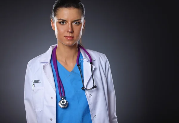 Young doctor woman with stethoscope isolated on grey background — Stock Photo, Image