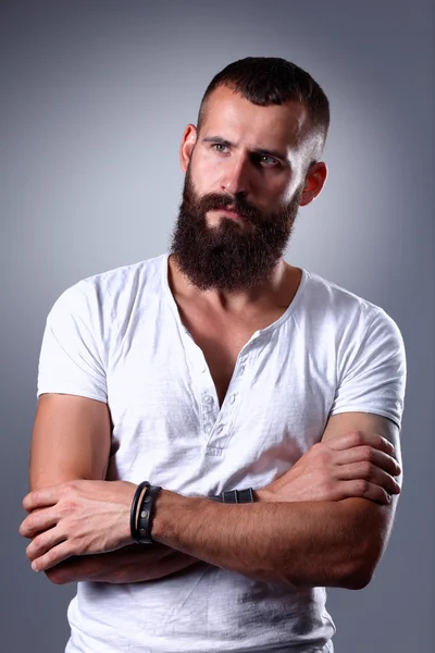 Portrait of handsome bearded man standing, isolated on grey background — Stock Photo, Image