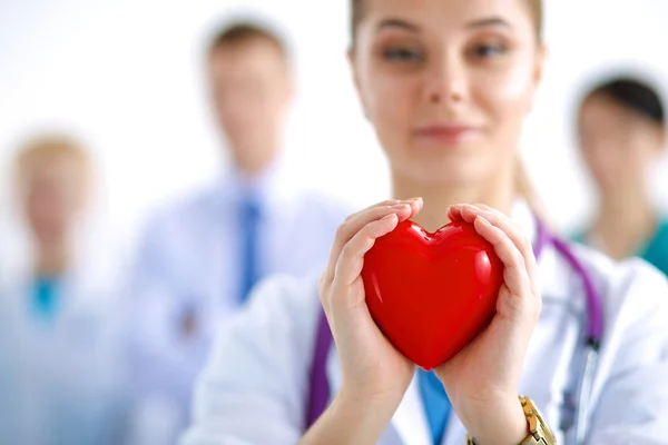 Female doctor with stethoscope holding heart — Stock Photo, Image