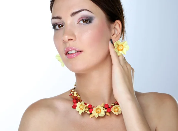 Portrait of young beautiful brunette woman in beads — Stock Photo, Image