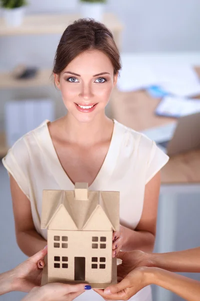 Portrait of female architect with blueprints at desk in office — Stock Photo, Image