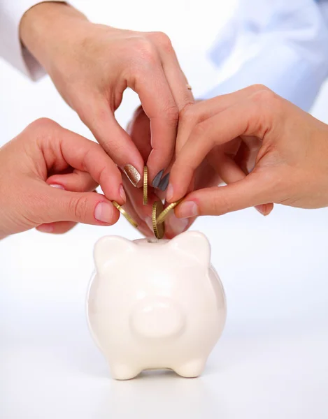 Putting coin into the piggy bank — Stock Photo, Image