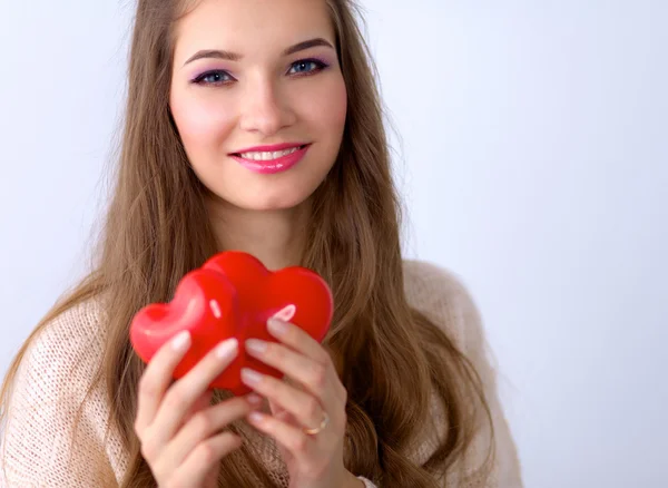 Portrait of beautiful happy woman holding a symbol heart. — Stock Photo, Image