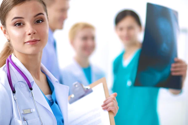 Woman doctor standing with folder at hospital — Stock Photo, Image