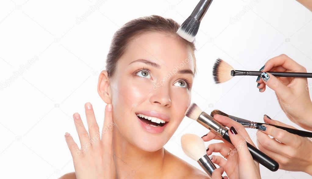 Closeup portrait picture of beautiful woman with brushes