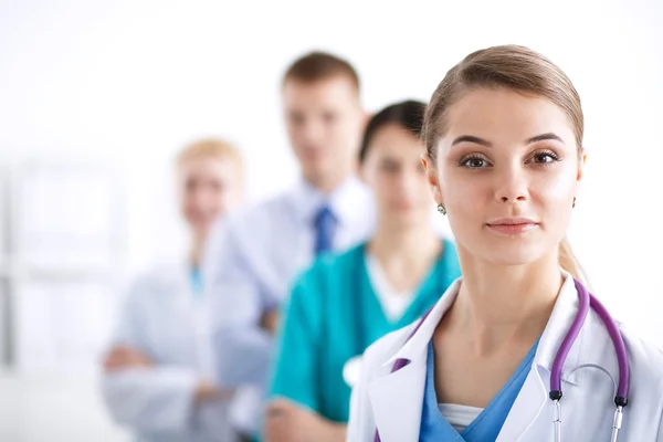 Attractive female doctor in front of medical group — Stock Photo, Image