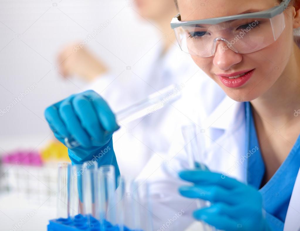 Woman researcher is surrounded by medical vials and flasks, isolated on white background