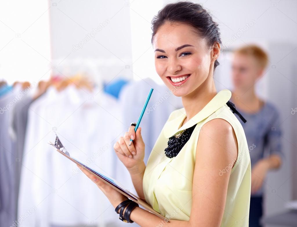 Modern young fashion designer working at studio.