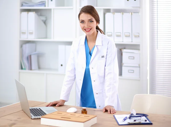 Portrait of young woman doctor with white coat standing in hospital — Stock Photo, Image