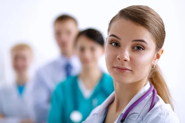 Attractive female doctor in front of medical group — Stock Photo, Image