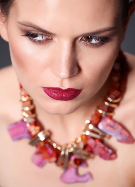 Portrait of young beautiful brunette woman in beads — Stock Photo, Image