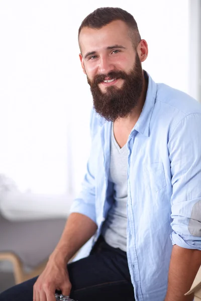 Young businessman sitting on chair in office — Stock Photo, Image