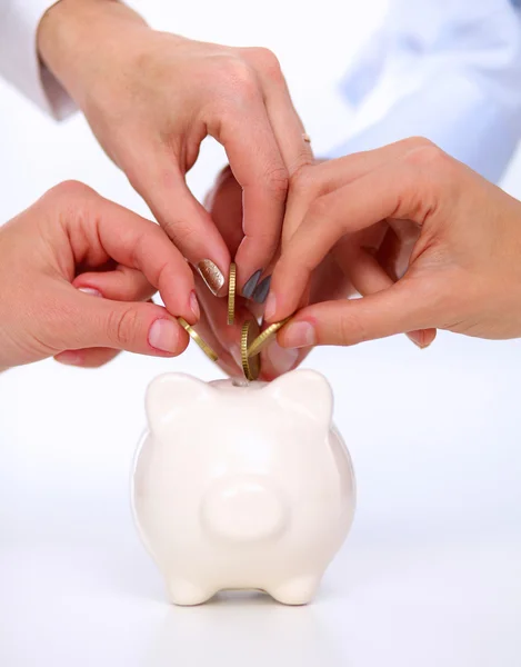 Putting coin into the piggy bank — Stock Photo, Image