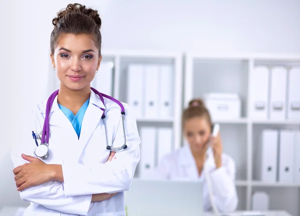 Portrait of young woman doctor with white coat standing in hospital — Stock Photo, Image