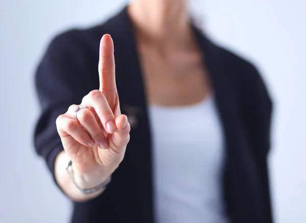 Vrouw die een denkbeeldig scherm met haar vinger aanraakt - geïsoleerd — Stockfoto