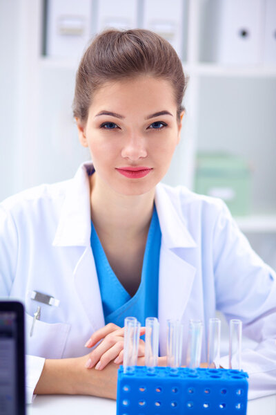 Woman researcher is surrounded by medical vials and flasks, isolated on white background