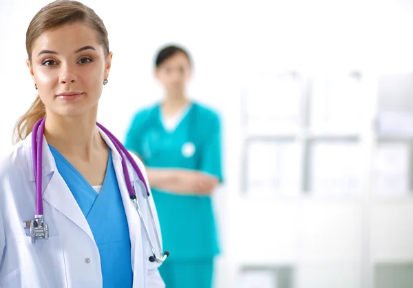 Woman doctor standing with stethoscope at hospital — Stock Photo, Image