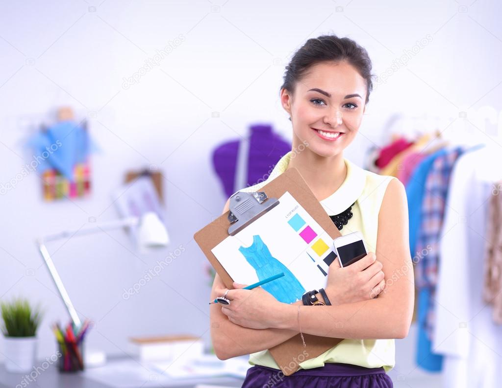 Modern young fashion designer working at studio.