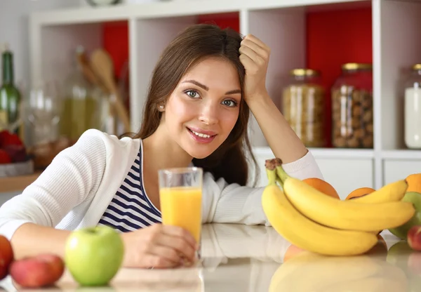 Portrait of a pretty woman holding glass with tasty juice — Stock Photo, Image