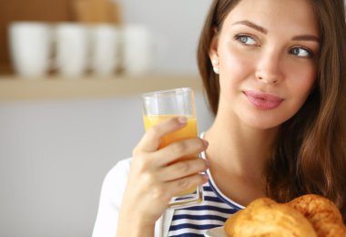 Young woman with glass of juice and cakes clipart