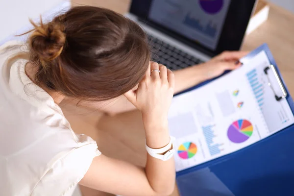 Portrait of tired young business woman with laptop computer at the office — Stock Photo, Image