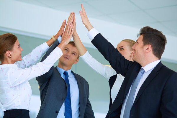 Business people with their hands together in a circle