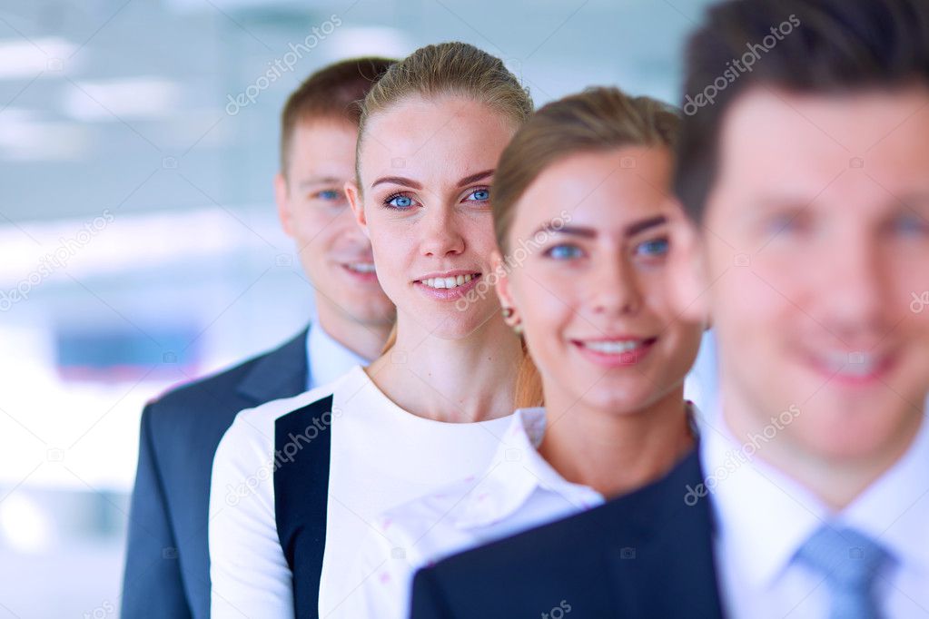 Smiling successful business team standing in office