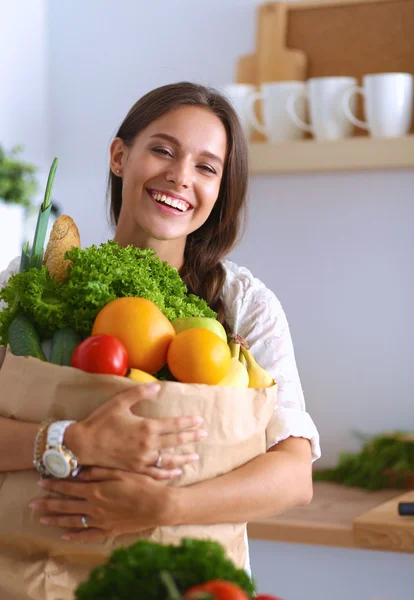 Mujer joven sosteniendo bolsa de la compra de comestibles con verduras y frutas — Foto de Stock
