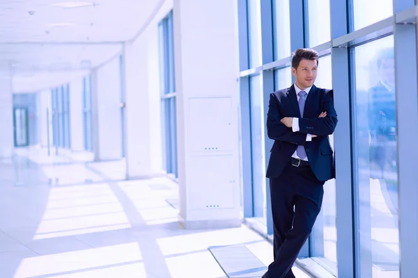 Retrato del hombre de negocios de pie cerca de la ventana en la oficina —  Fotos de Stock