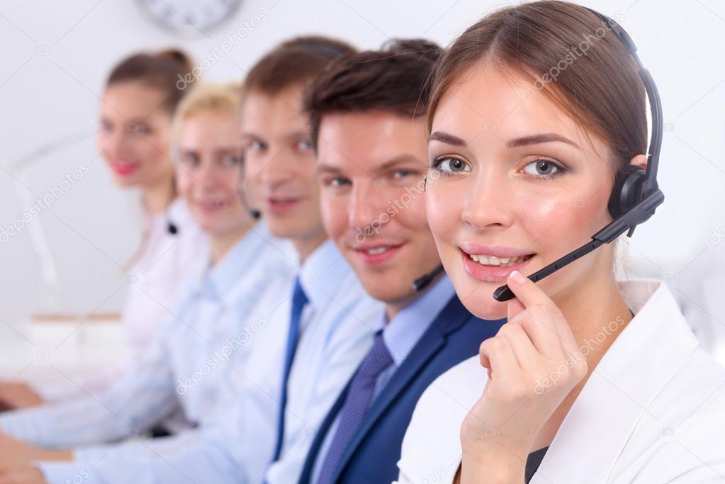 Attractive Smiling positive young businesspeople and colleagues in a call center office