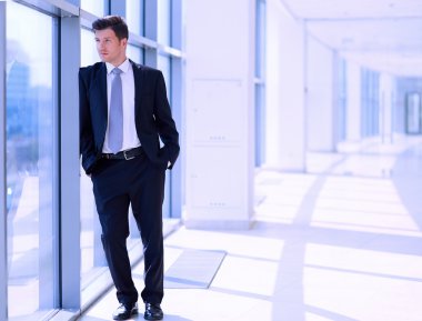 Ofisteki pencerenin yanında duran işadamının portresi