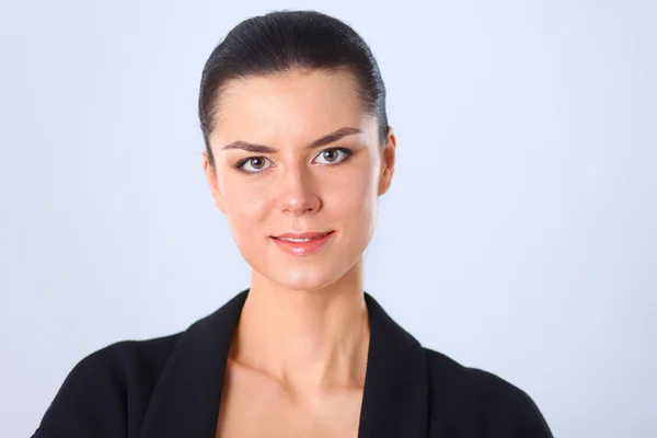 Young woman standing, isolated on gray background — Stock Photo, Image