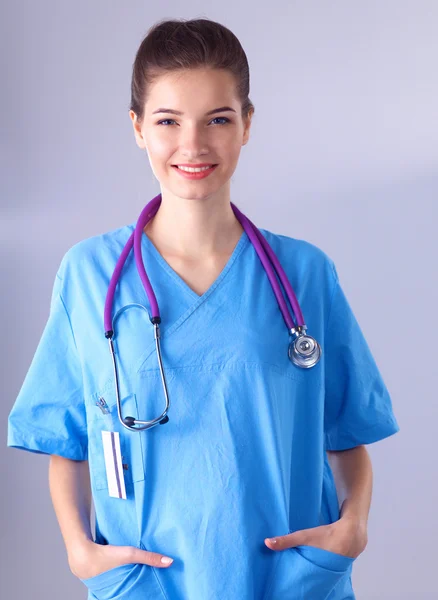 Portrait of young woman doctor standing in hospital Stock Picture