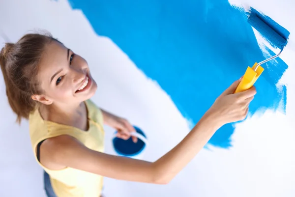 Beautiful young woman doing wall painting — Stock Photo, Image