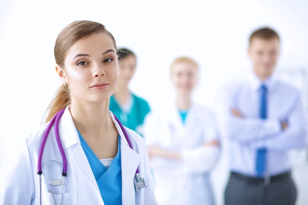 Attractive female doctor in front of medical group — Stock Photo, Image