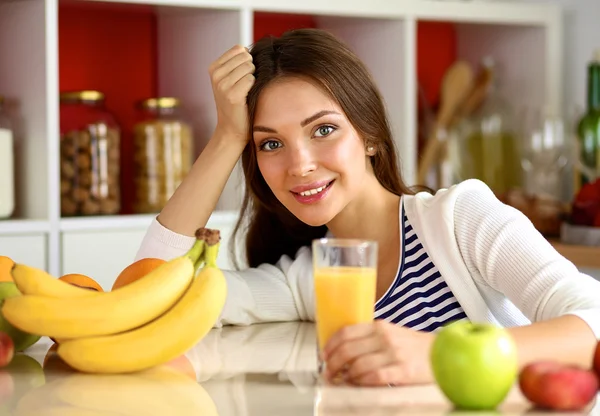 Portrait of a pretty woman holding glass with tasty juice — Stock Photo, Image