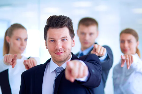 Group of business people pointing to you