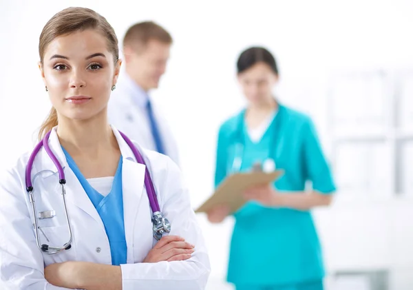 Attractive female doctor in front of medical group — Stock Photo, Image