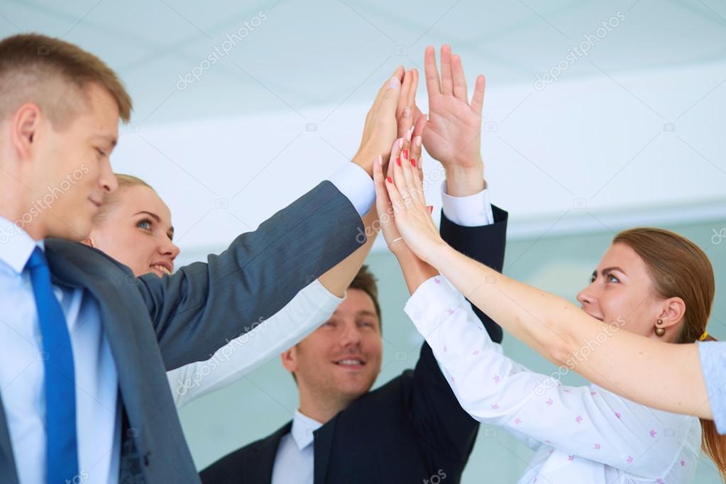 Business people with their hands together in a circle