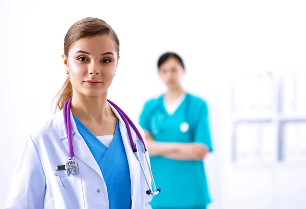 Woman doctor standing with stethoscope at hospital — Stock Photo, Image