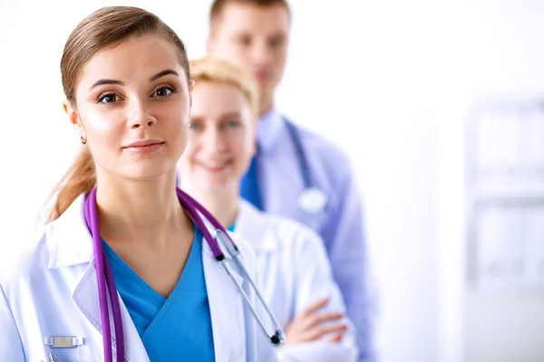 Attractive female doctor in front of medical group — Stock Photo, Image