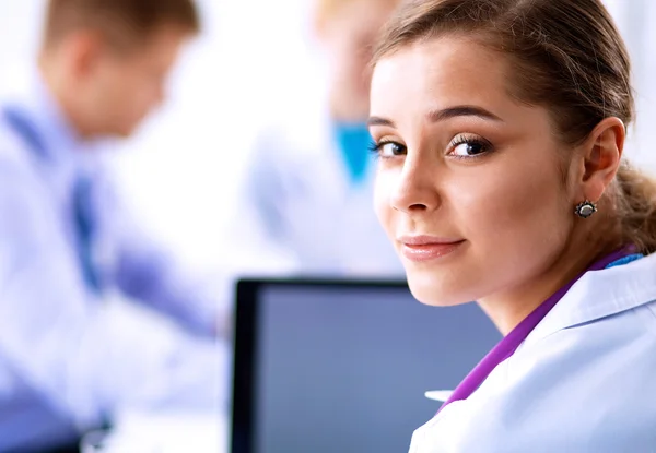 Medical team sitting at the table in modern hospital — Stock Photo, Image