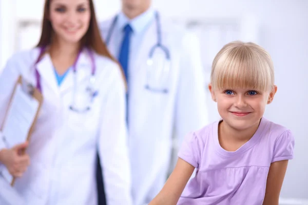 Female doctor examining child with stethoscope at surgery — Stock Photo, Image